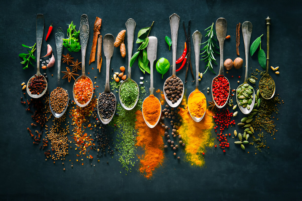 Assorted premium spices including paprika, turmeric, and cinnamon, arranged for cooking inspiration